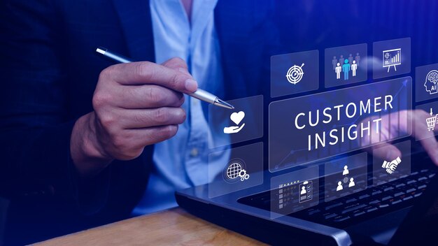 Business professional using a digital interface on a laptop, highlighting customer insight and data analytics icons.